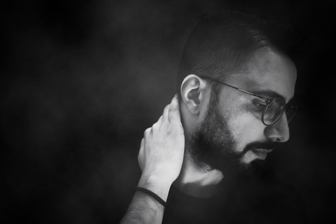 Studio portrait of a bearded man in glasses