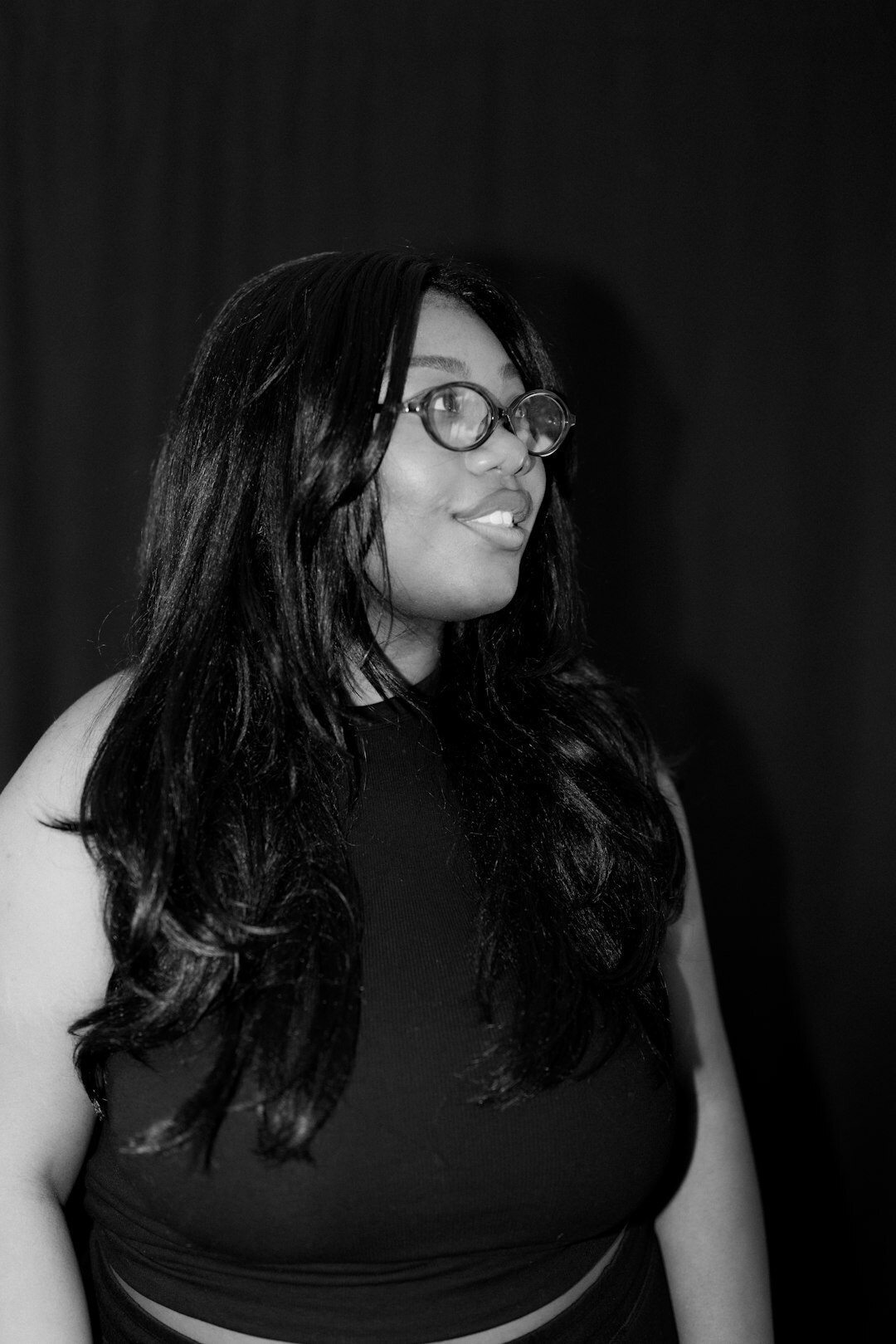 Studio portrait of a woman with glasses smiling
