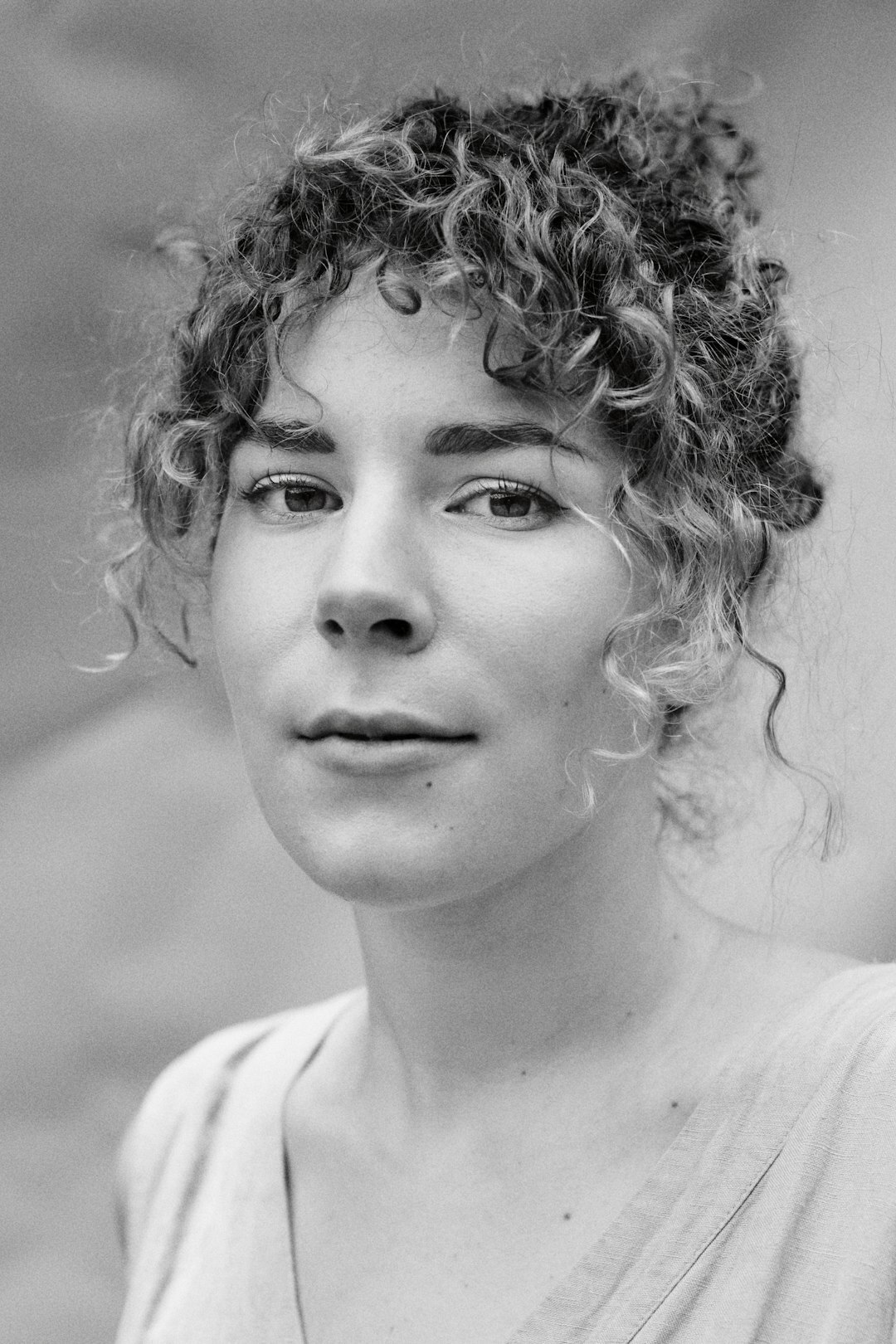 Studio portrait of a young woman with curly hair